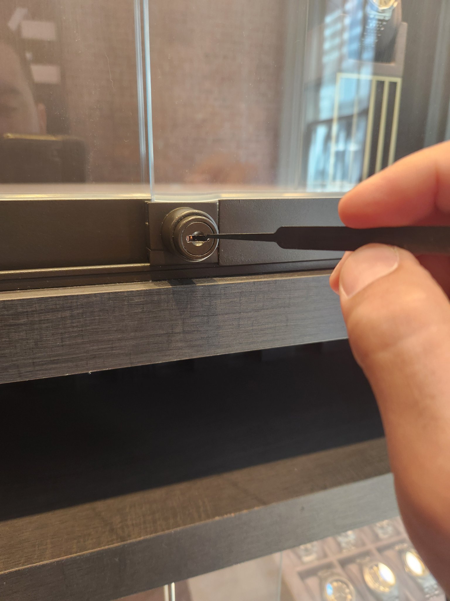 Precision lock servicing on a glass display case