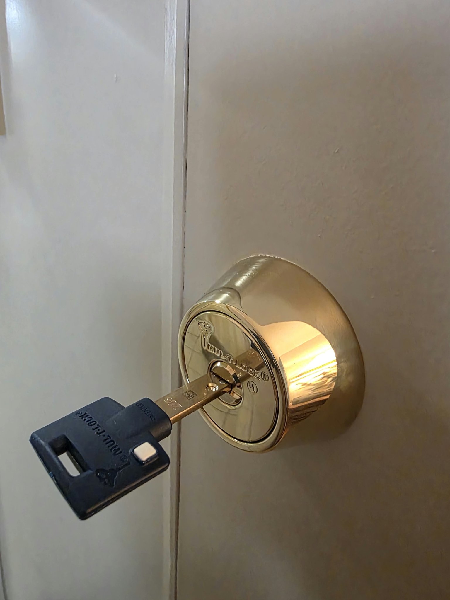 Mul-T-Lock high-security deadbolt with key, installed on an interior door