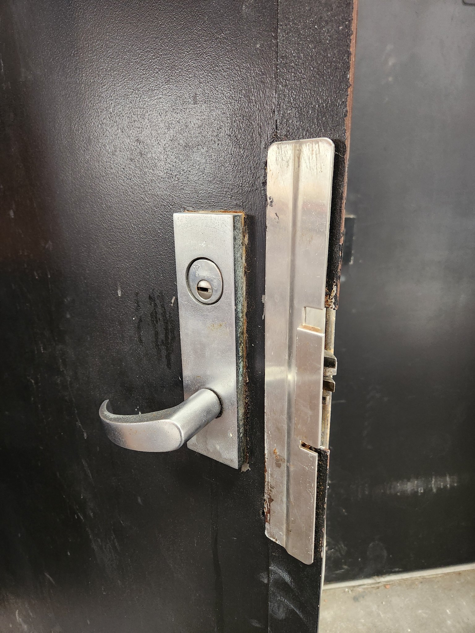 Storefront door with Mul-T-Lock lever hardware and latch guard